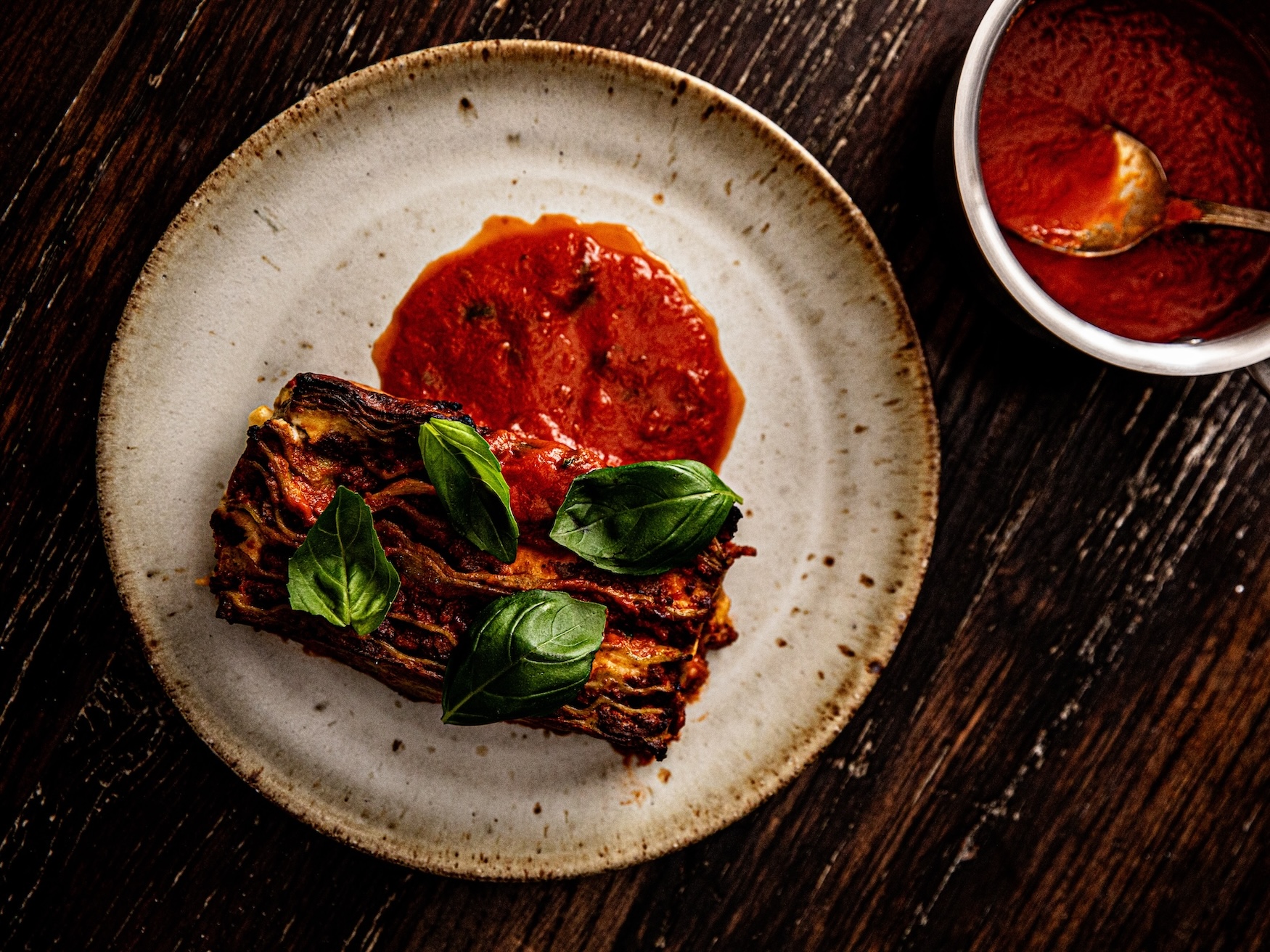 Cane Pazzo lasagna topped with fresh basil